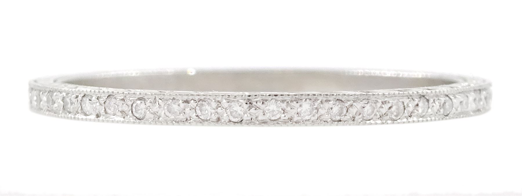 Platinum diamond full eternity ring, the sides with engraved decoration