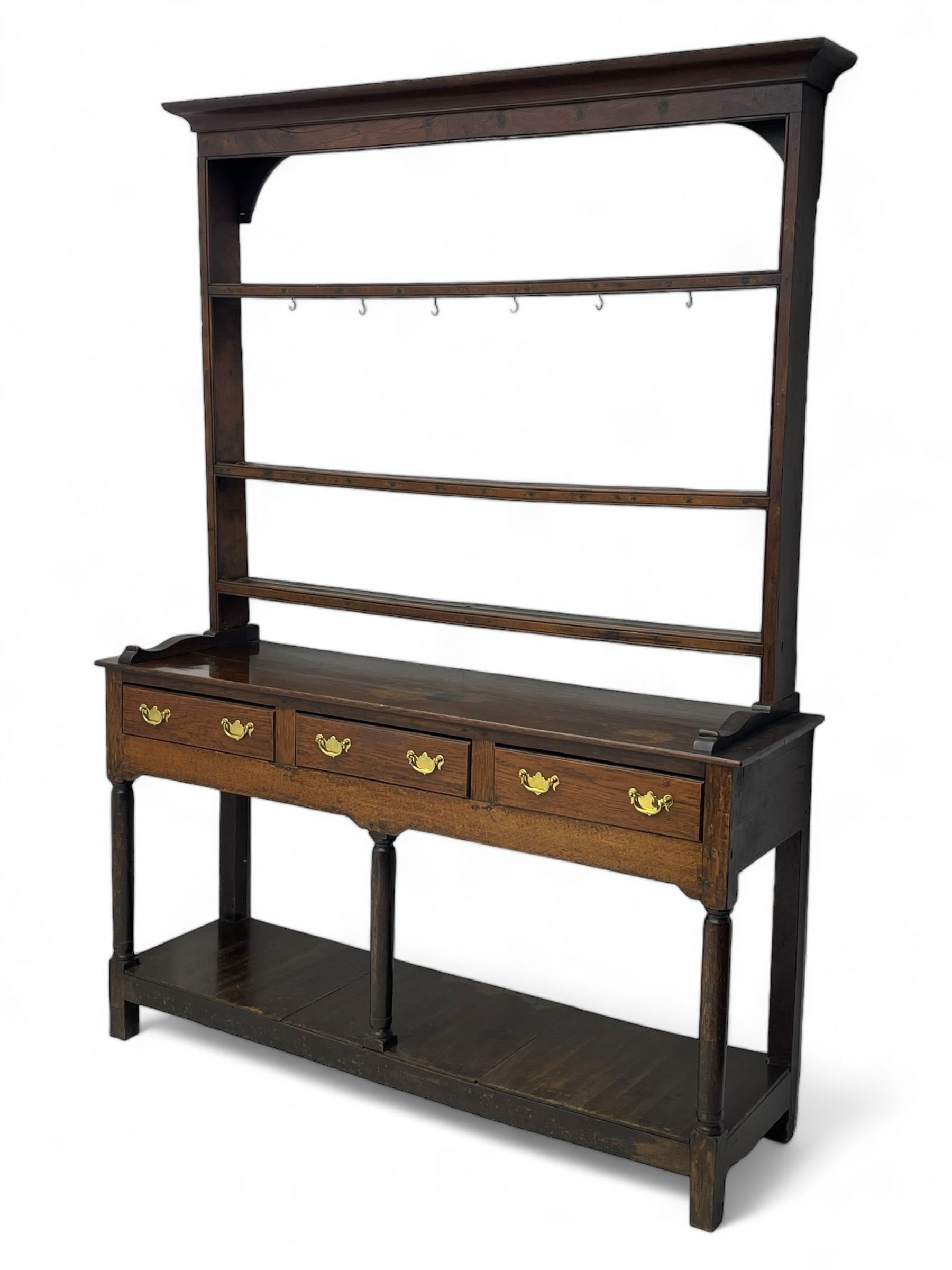 18th century oak dresser, raised three tier plate rack with moulded cresting rail, rectangular top over three drawers, the drawer fronts with moulded edges, turned supports united by pot board base 