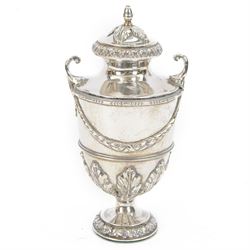 Edwardian silver twin handled urn, of circular form, decorated in relief with acanthus lea...