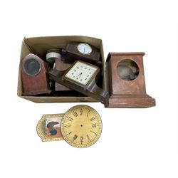 An assortment of mantle clocks and empty wooden cases