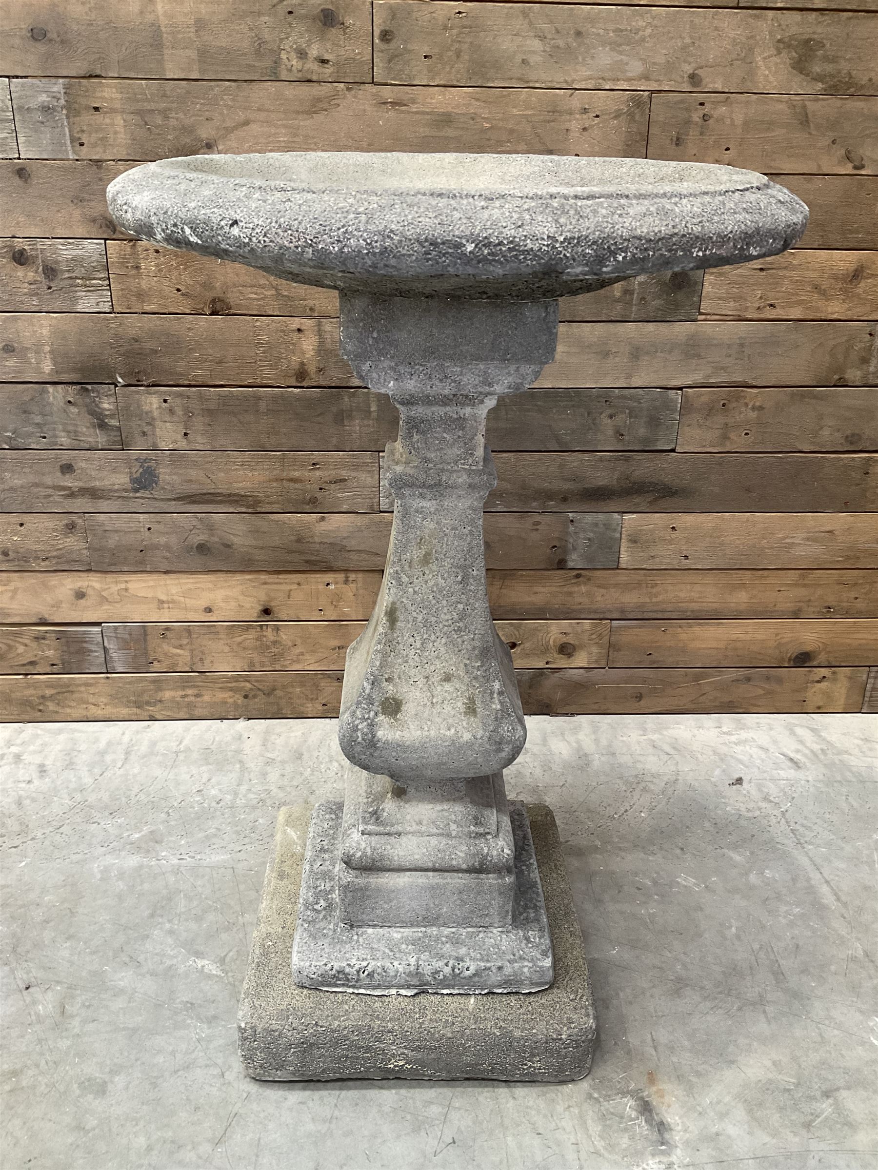 Cast stone garden bird bath, circular dished top, raised on square tapering column, on stepped base with separate mounting plinth