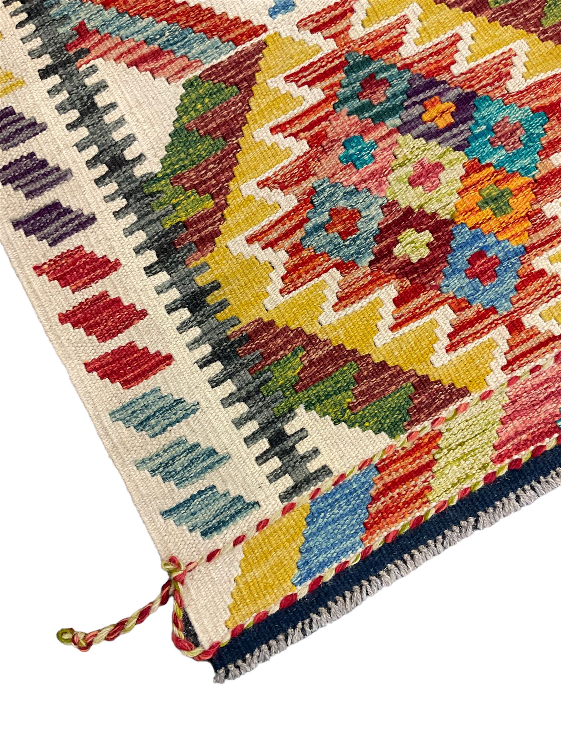 Chobi Kilim rug, pale ground and decorated with multi-coloured geometric pattern 