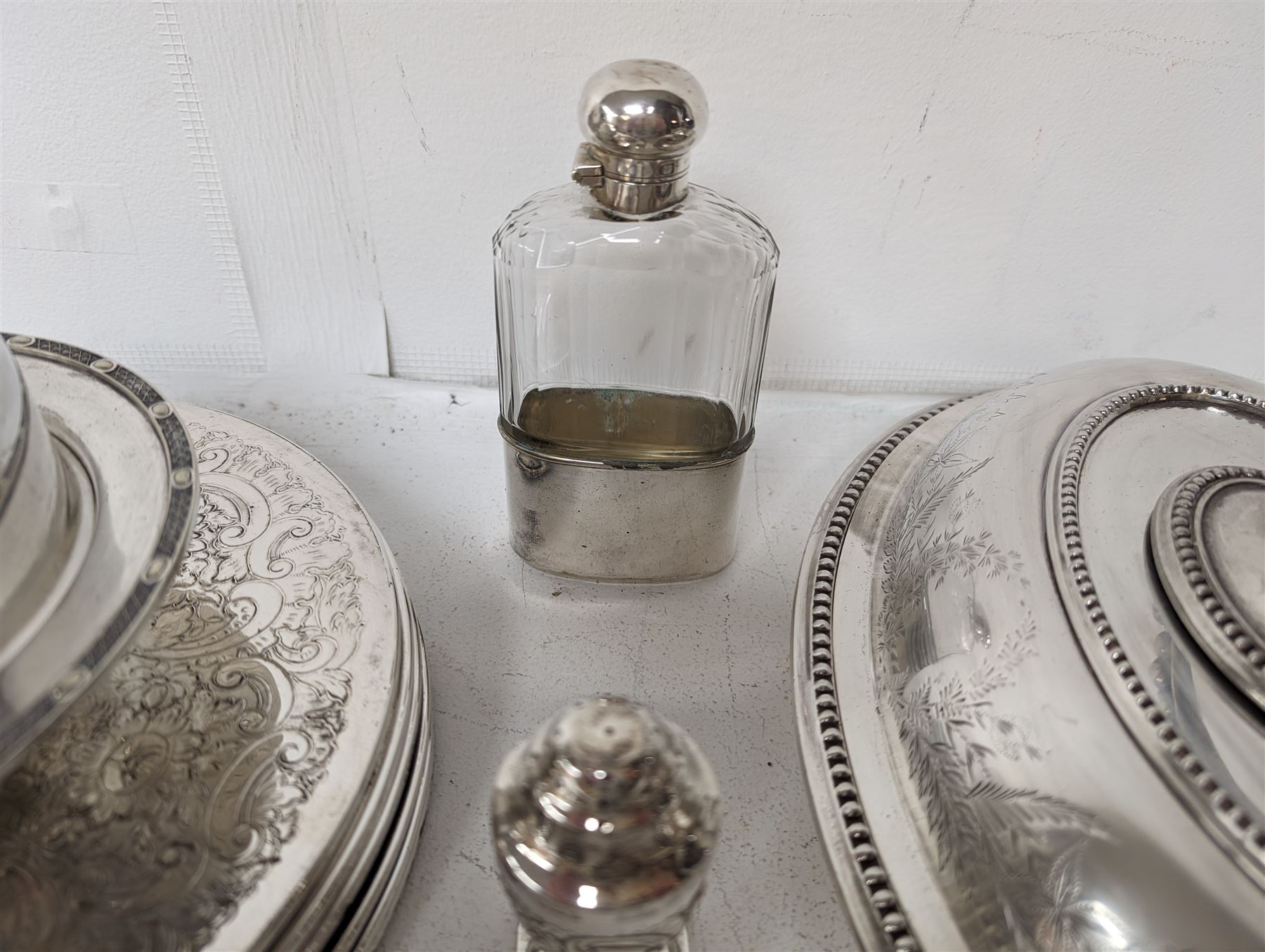 Glass hip flask, with silver cap/collar and plated cup and a silver topped pepper shaker, together with silver plated items including place mats, coasters, serving dishes, etc