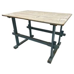 Early 20th century pine rustic dining table, rectangular plank top with weathered patina, over trestle-style supports in distressed blue paint with central stretcher