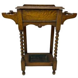 Early 20th century oak work table or hall stand, rectangular top with hinged lid enclosing interior storage, side hanging handles, barley twist supports united by square stretchers, on turned feet