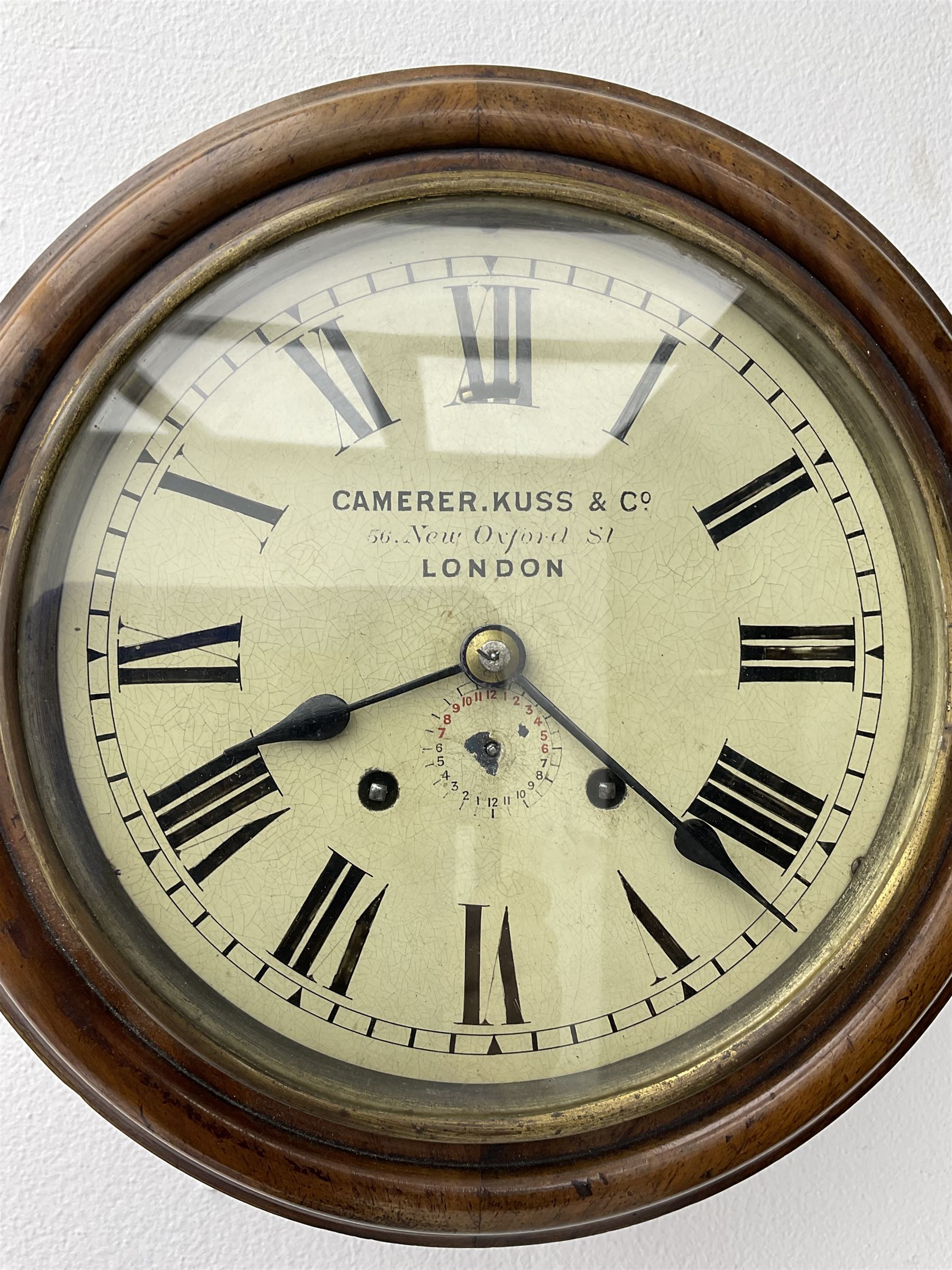 Camerer Kuss & Co -  8-day wall clock with alarm, mahogany dial surround and brass bezel, 8