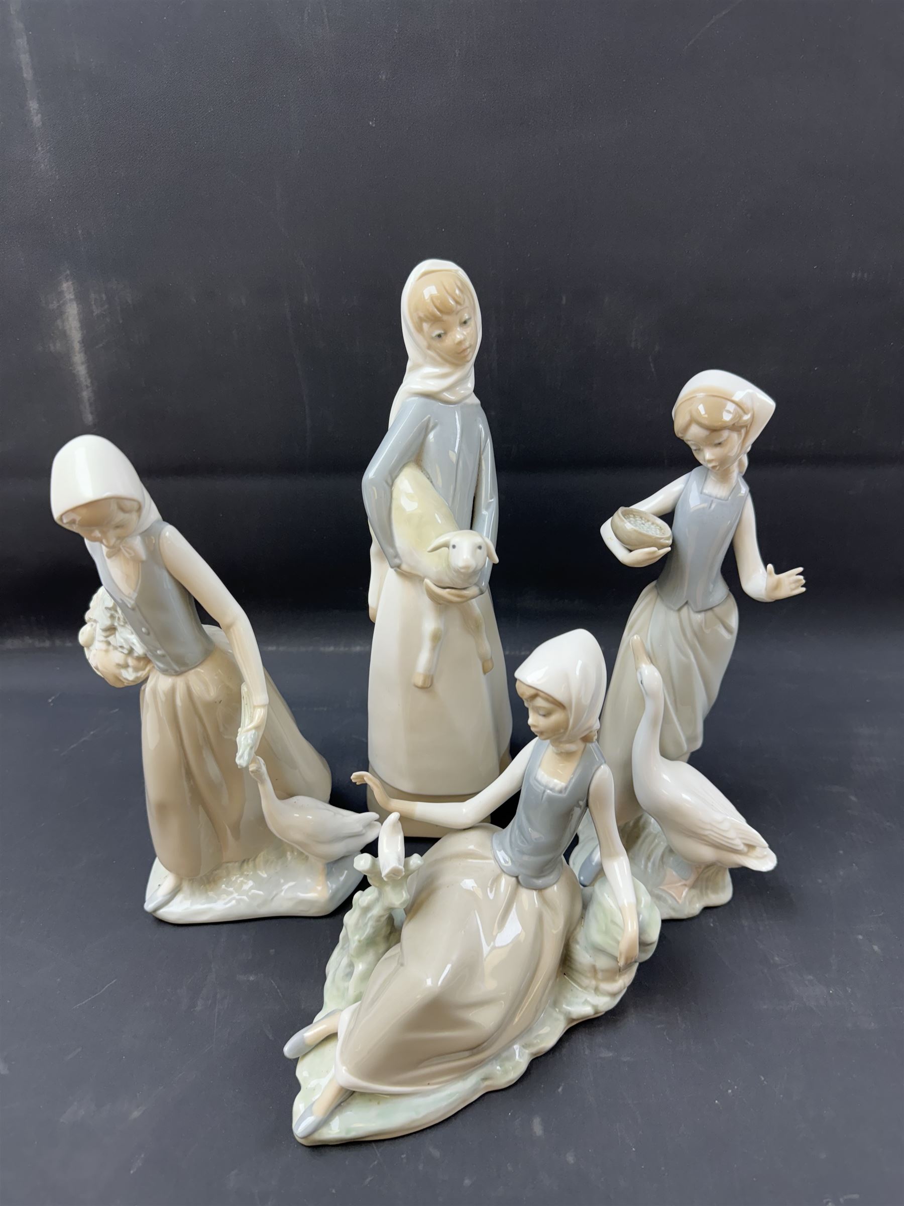 Four Lladro figures, including Girl with Lamb, Girl with Dove etc