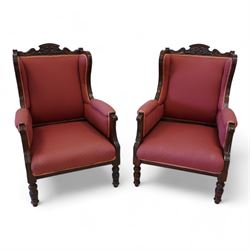 Pair of late Victorian walnut armchairs, shaped cresting rail carved with curling leaves, ...