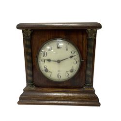 Assortment of three mantle clocks and an aneroid barometer.