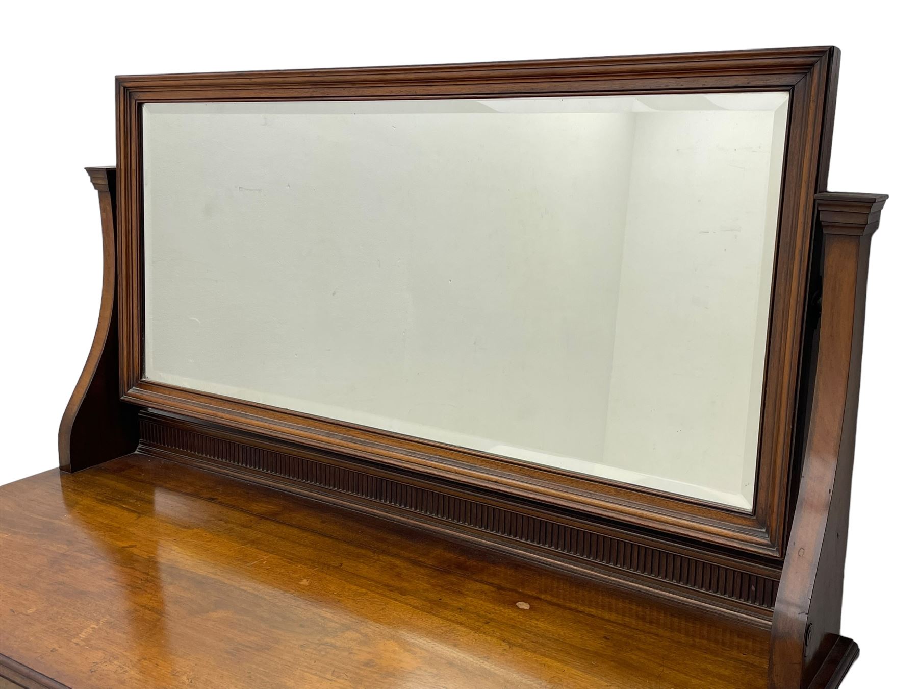 Late 19th century walnut dressing table, wide rectangular bevelled swing mirror in moulded frame, shaped horns carved with scrolls, moulded rectangular top over seven drawers, on square tapering supports with spade feet 