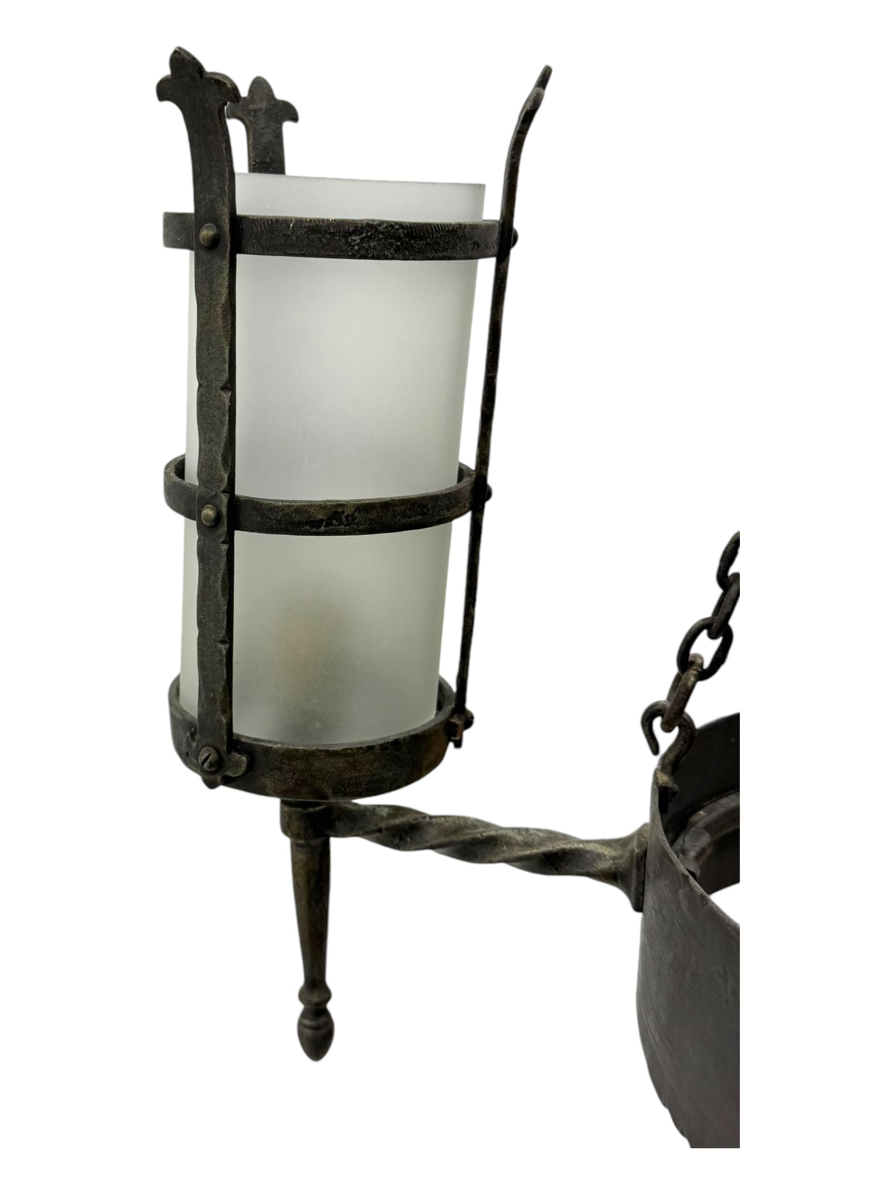 Wrought metal ceiling light, four branch with strapwork lanterns (D55cm); together with a pair of matching wall sconces (H32cm)