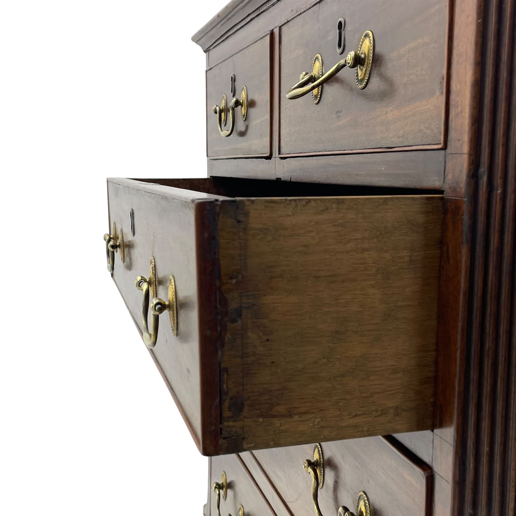 Small George III mahogany chest, rectangular canted form, moulded top over two short and three long cock-beaded drawers, fitted with brass swan neck handles and oval plates, enclosed by fluted upright corners, on bracket feet 