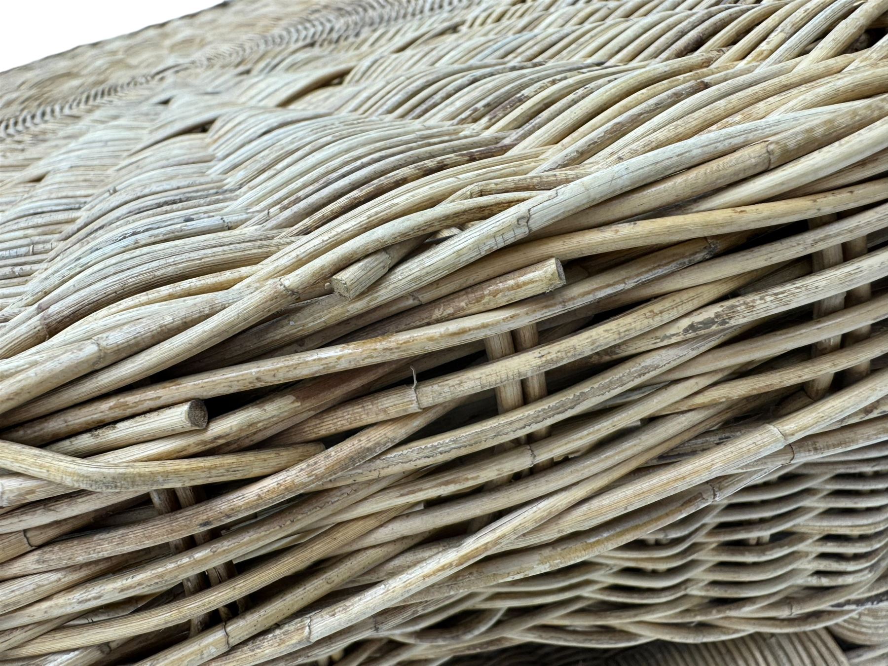 Mid-20th century hexagonal wicker coffee table, featuring woven top with pattern that radiates from the centre, lower shelf for additional storage, supported by interwoven wicker legs