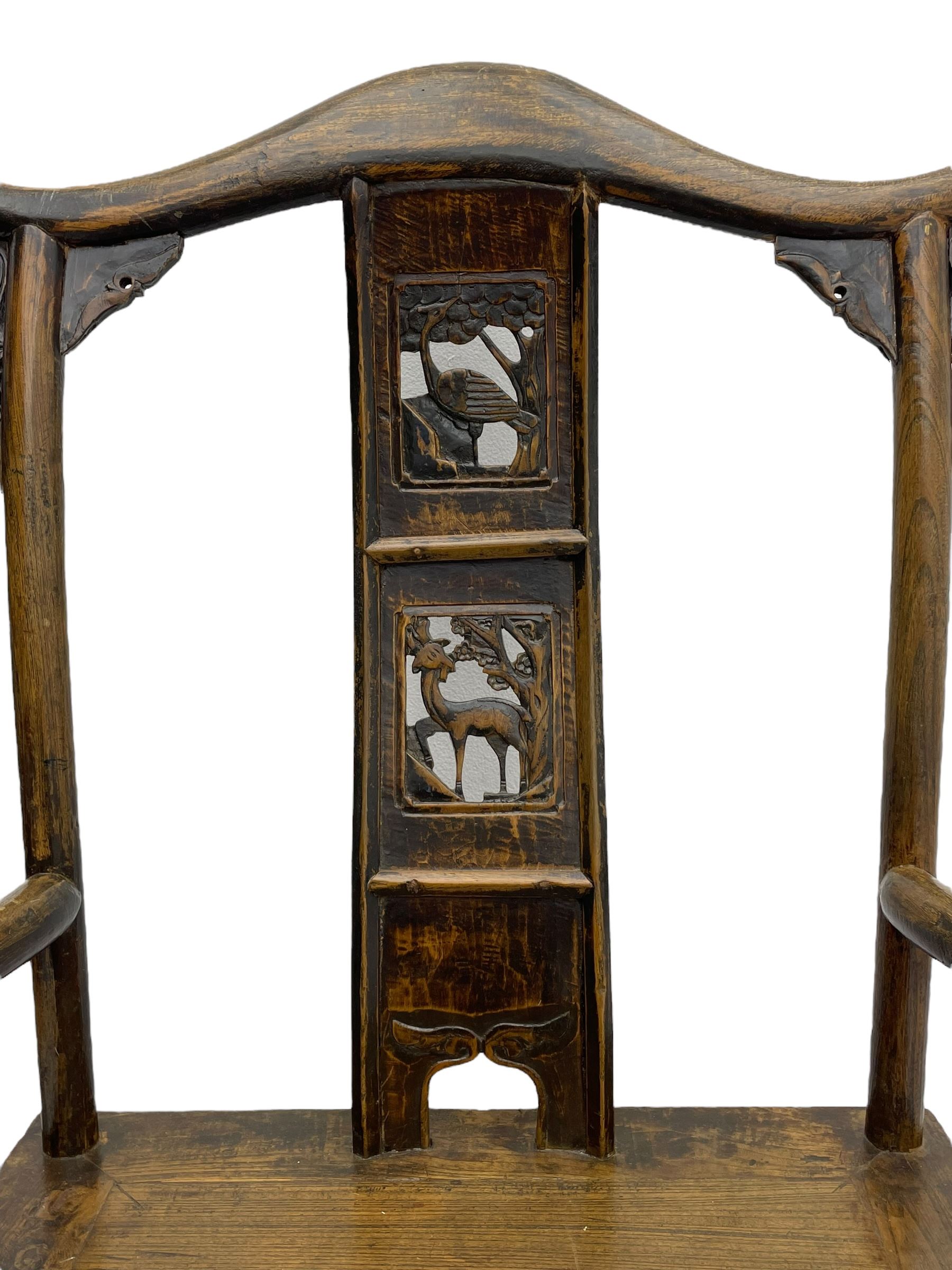 Chinese design elm yoke back 'official's' armchair, the shaped cresting rail over splat decorated with carved and pierced wildlife scenes, shaped projecting arms over rectangular seat, square supports united by plain stretchers, decorated with shaped frame brackets carved with foliage