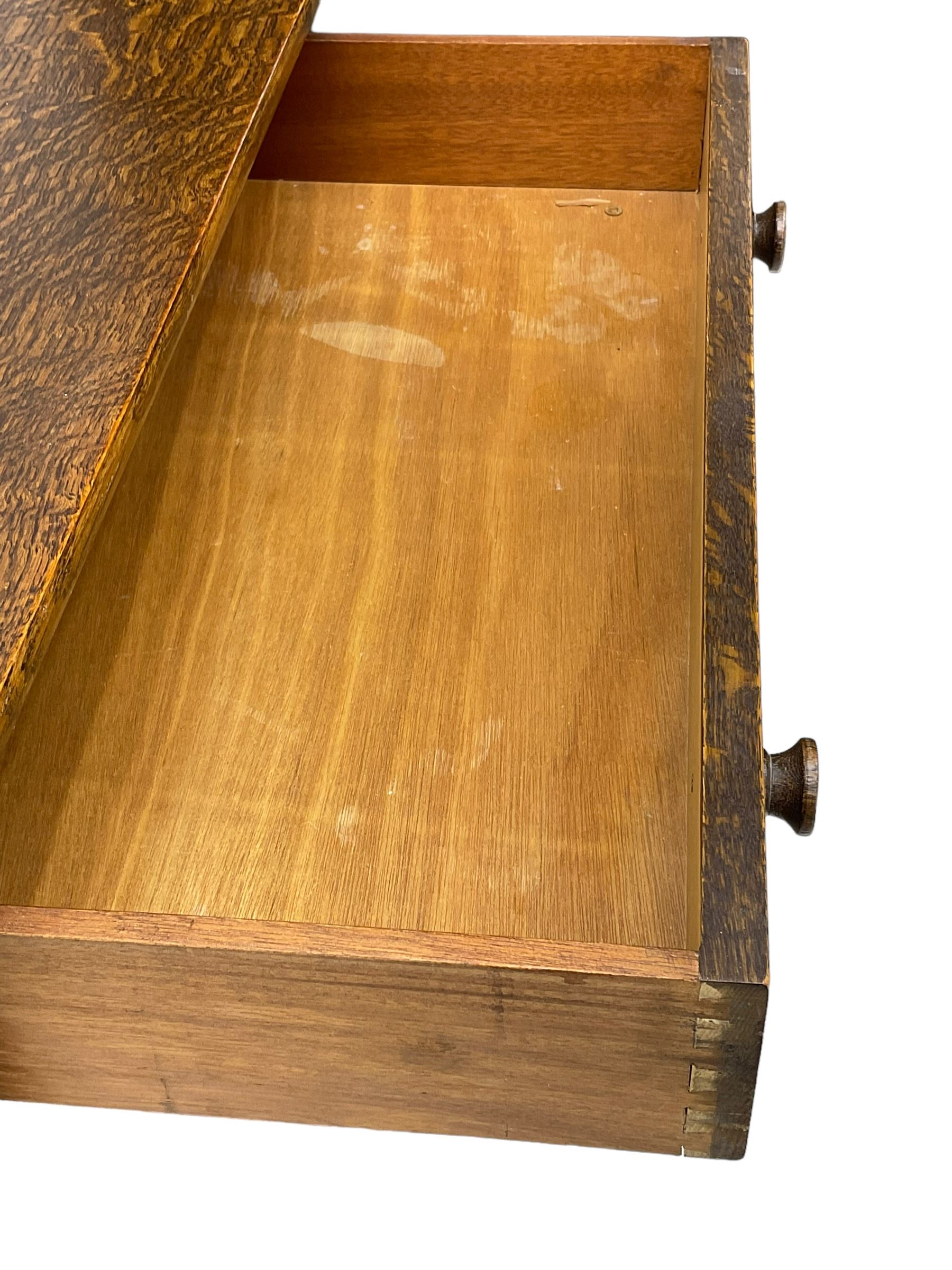 Mid-20th century oak chest, fitted with five drawers, the top drawer carved with flower head roundels, on bracketed plinth base 