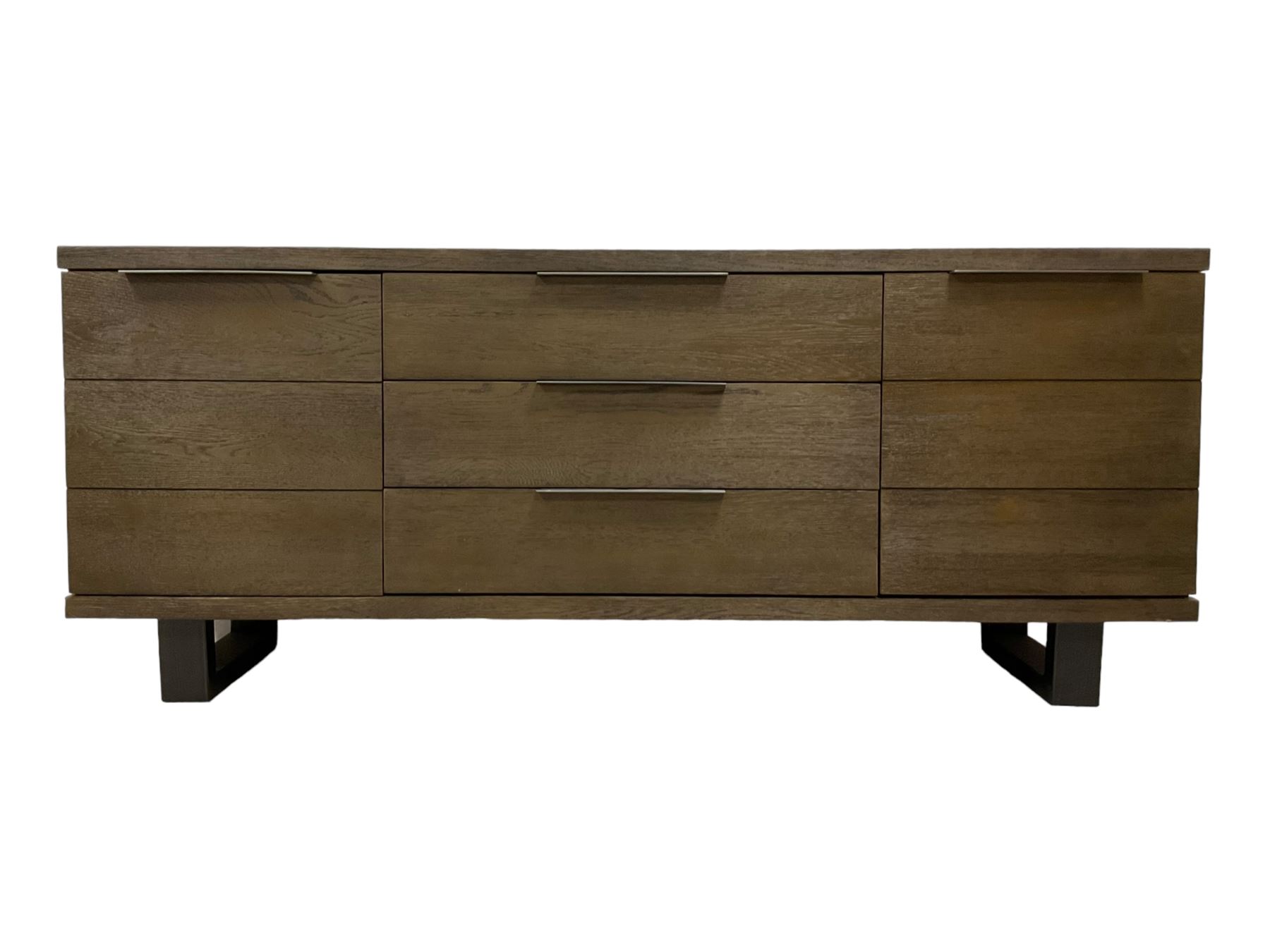 Contemporary dark oak finish sideboard, three central drawers flanked by single cupboards, on angular black finish metal supports 