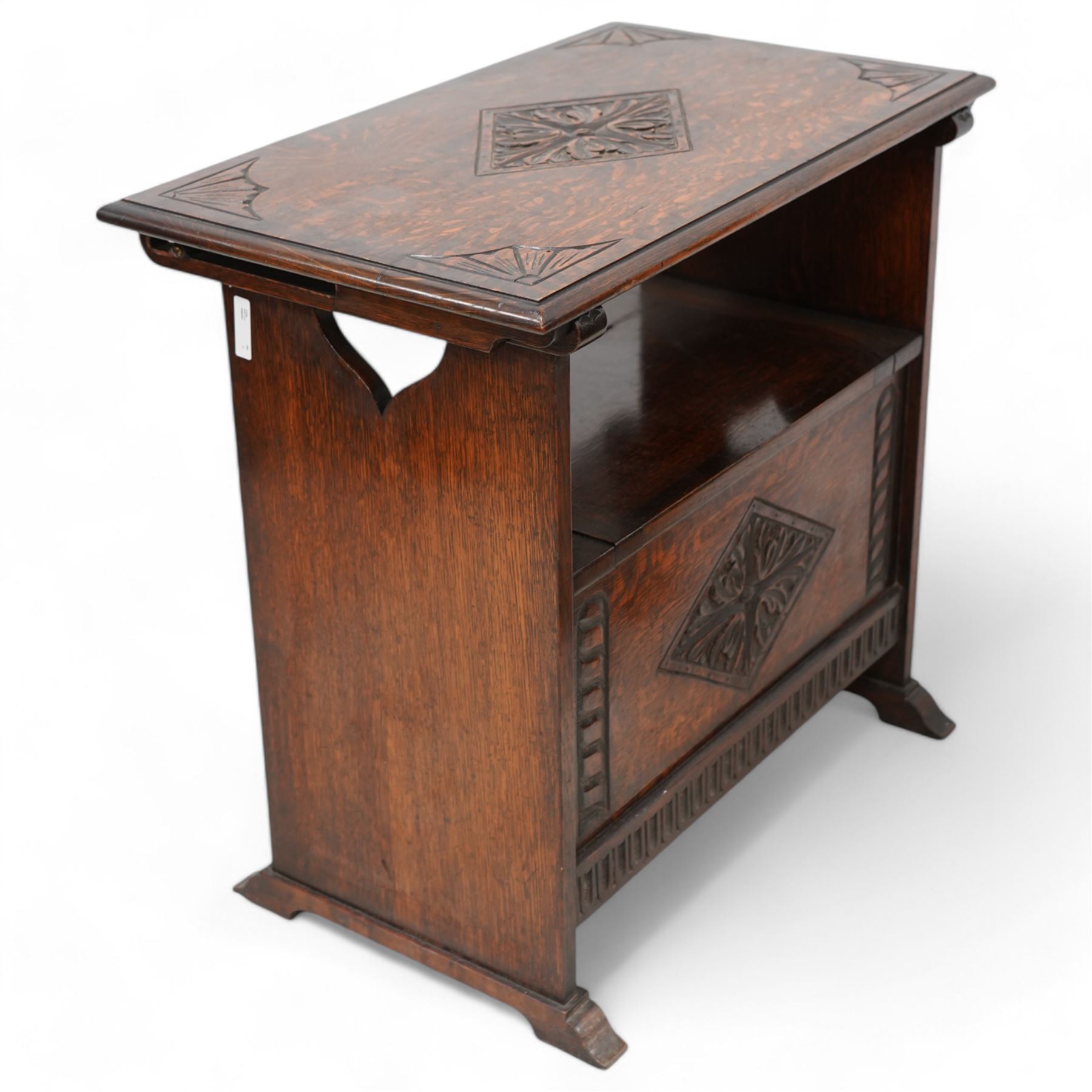 Early-to-mid-20th century carved oak monk's bench, metamorphic top with foliate lozenge carvings, over box seat with hinged lid, arcade carved lower rail on shaped feet