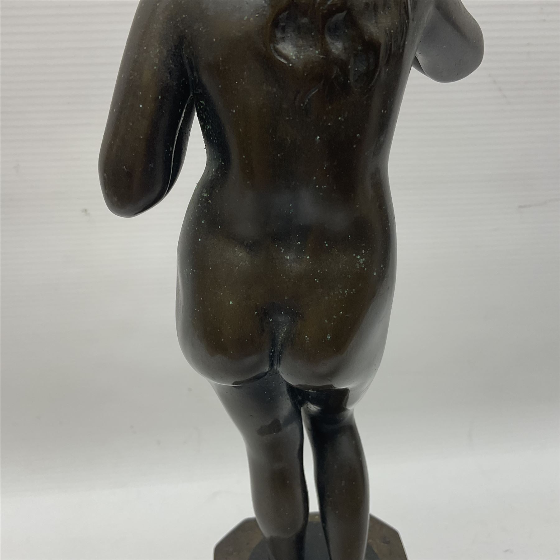 Bronze nude female figure holding a rose, upon a stone plinth, H40cm 