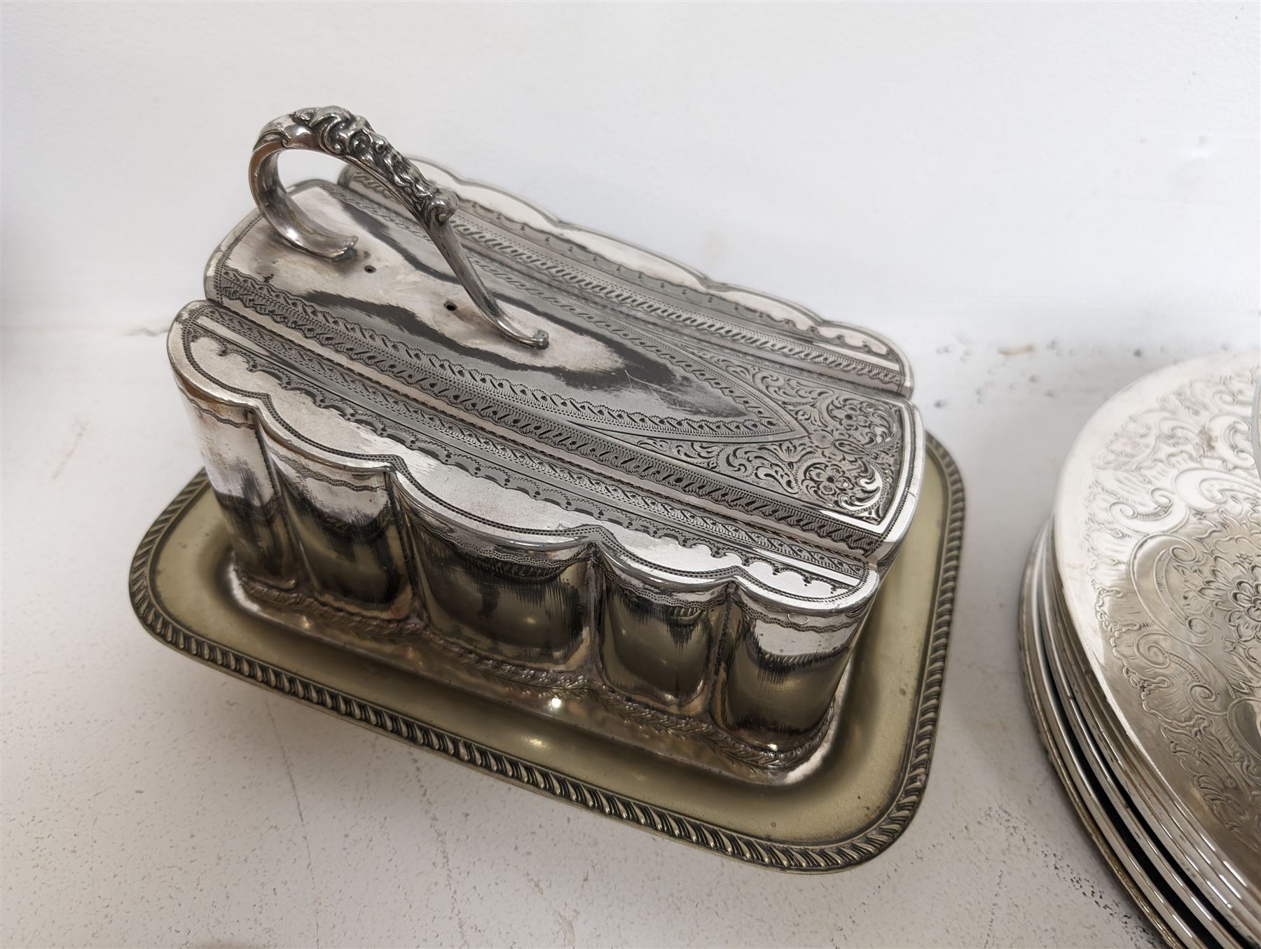 Glass hip flask, with silver cap/collar and plated cup and a silver topped pepper shaker, together with silver plated items including place mats, coasters, serving dishes, etc