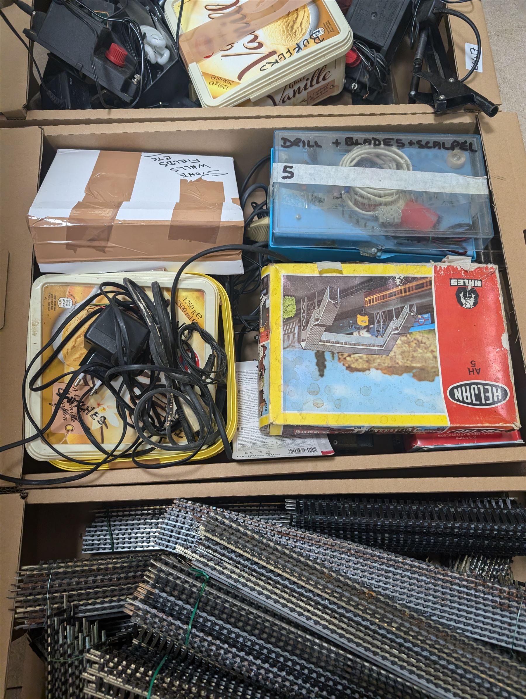 Collection of model railway accessories, including OO gauge track, control units etc, in four boxes 