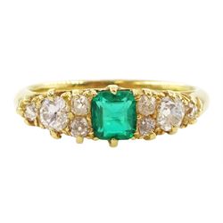 Early 20th century 18ct gold emerald and diamond ring, cushion cut emerald, with four diam...