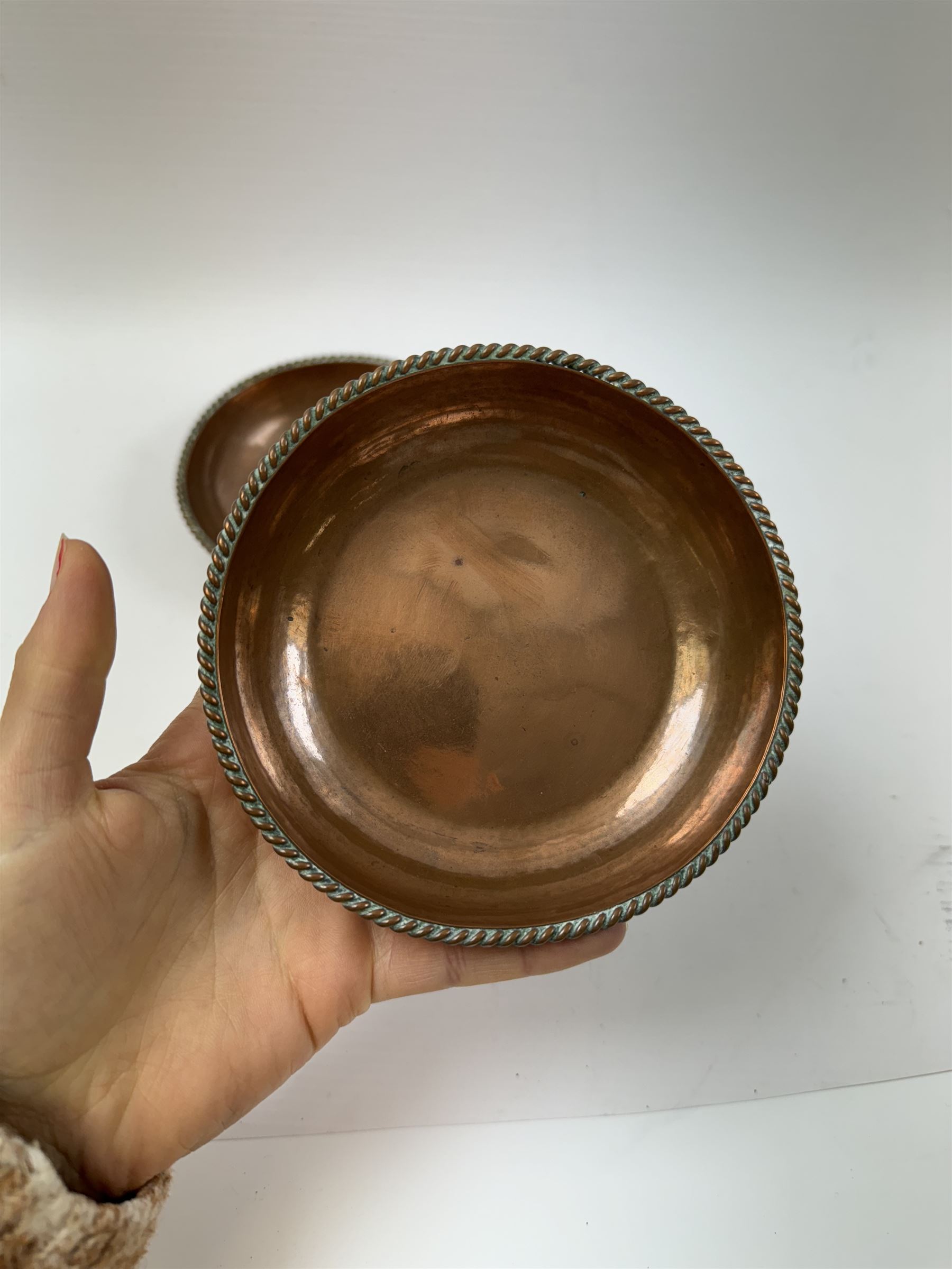 Pair of Arts & Crafts copper dishes by Gordon Russell, with lightly hammered finish and oblique gadrooned rim, impressed beneath 'Golf Hotel Grange Over Sands' and with maker's mark for Lygon