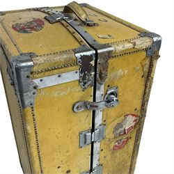 Early 20th century steamer traveling trunk, in yellow finish with chrome fixtures, the interior fitted with drawers and hangers, with various travel labels 