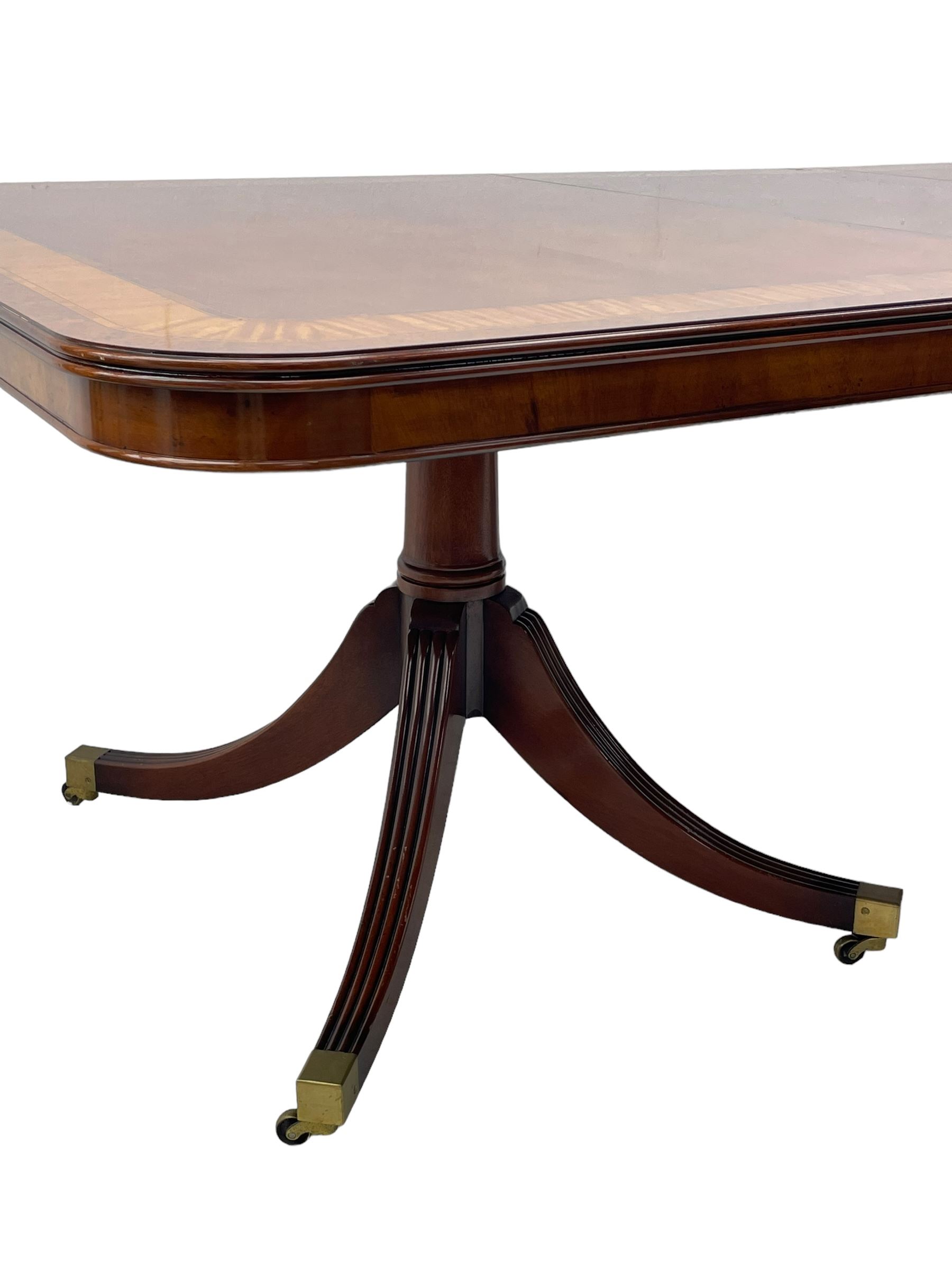 RBC Furniture (Made in England) - Georgian design mahogany dining table, rectangular top with rounded corners, satinwood and burr walnut bandings, two D-ends with two additional leaves and support rails, on barrel turned pedestals with four out-splayed reeded supports, brass cups and castors 