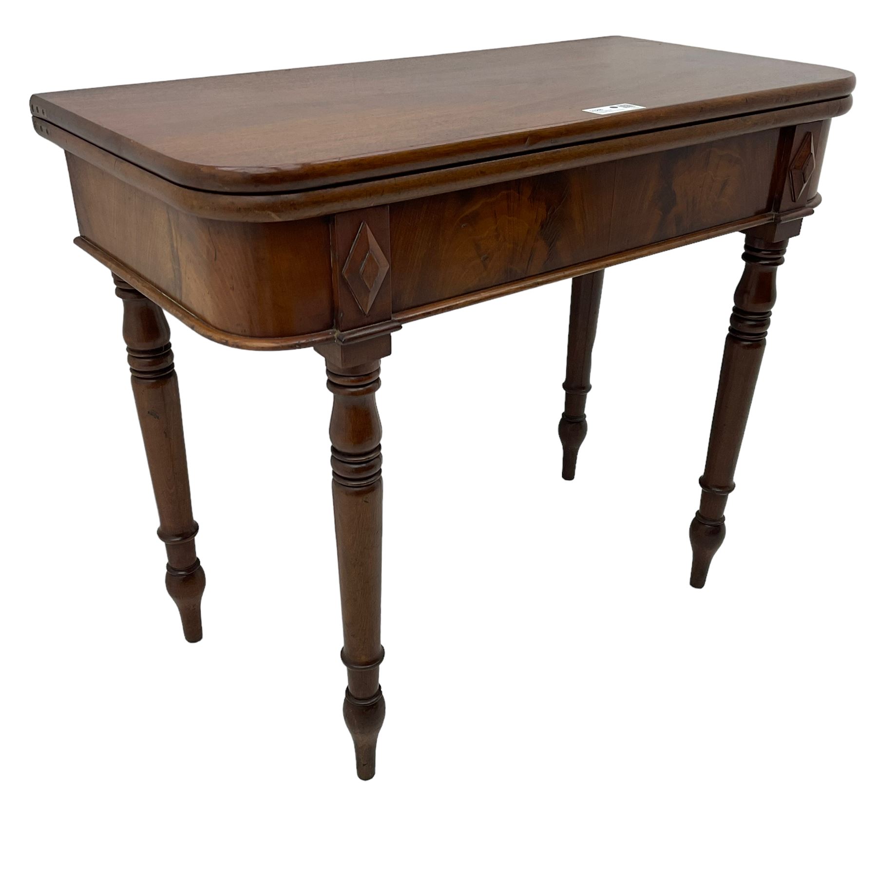 19th century mahogany tea table, fold-over swivel action rectangular top with rounded corners, figured frieze with stepped lozenge mounts, on turned supports