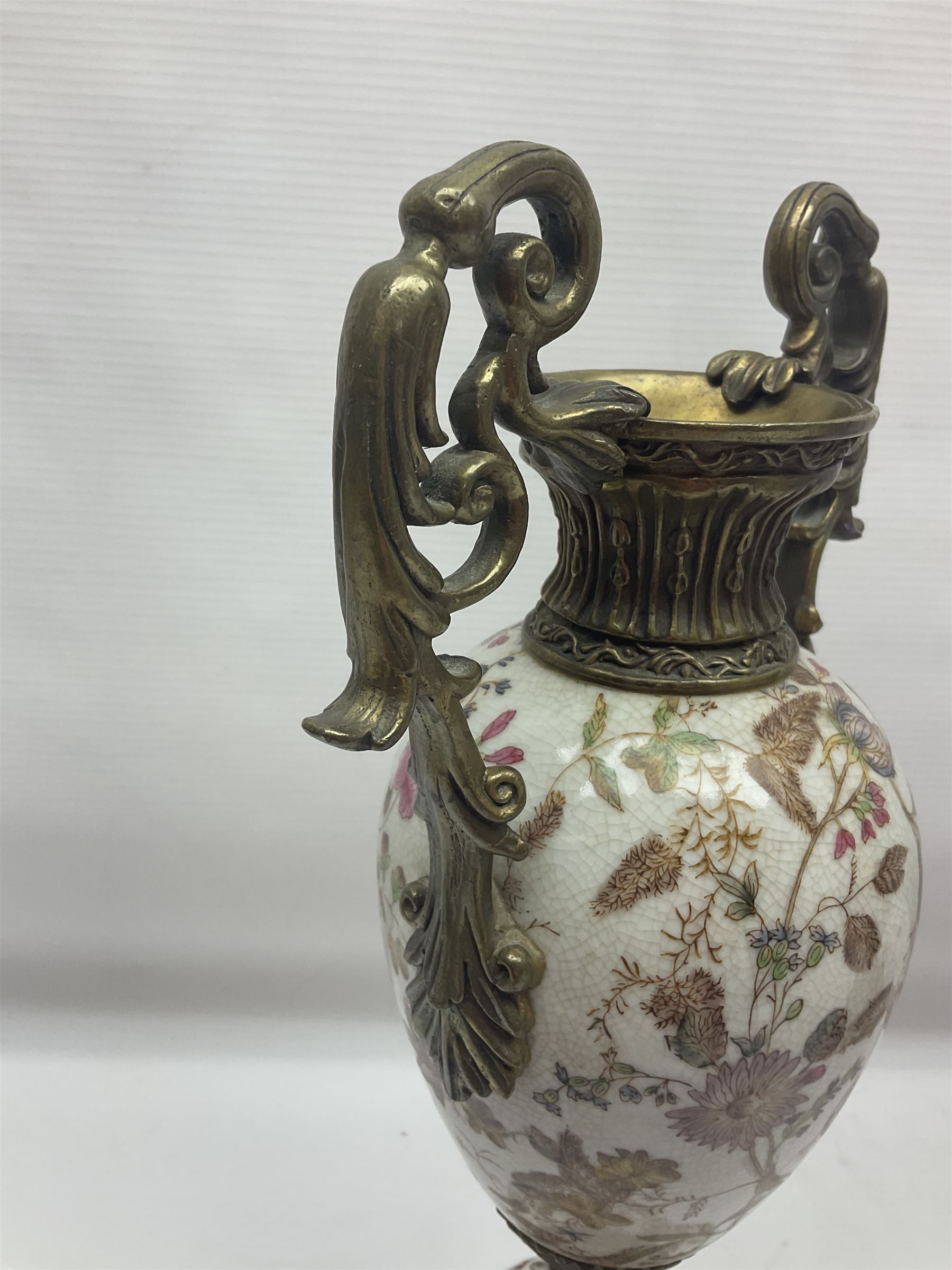 Wong Lee, twin handled ceramic urn with enamelled floral decoration and bronzed metal mounts, upon a square base, marked to base, together with similar twin handled urn with enamelled Cherub decoration, largest H44cm