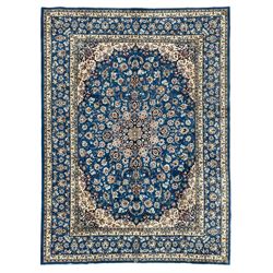 Persian Nain blue ground carpet, overall arabesque design, centre rosette medallion with eight projecting palmettes, the surrounding field decorated with interlacing branches and stylised plant motifs, within floral pale ground spandrels, the guarded border decorated with repeating stylised floral pattern 