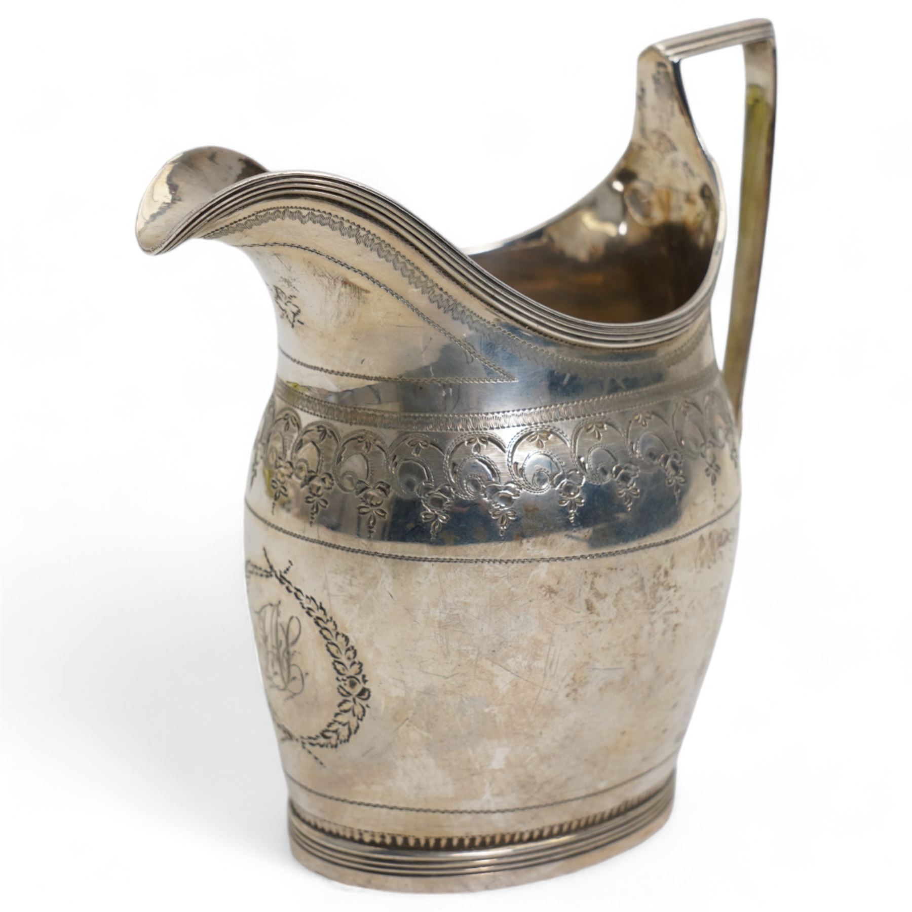 George III silver cream jug with engraved decoration and angular handle London 1796 Maker possibly George Wintle