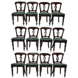 Matched set of twelve Victorian mahogany dining or boardroom chairs, the shaped cresting rail decorated with scrolled decoration, upholstered drop-on seats upholstered in green fabric, on turned supports  