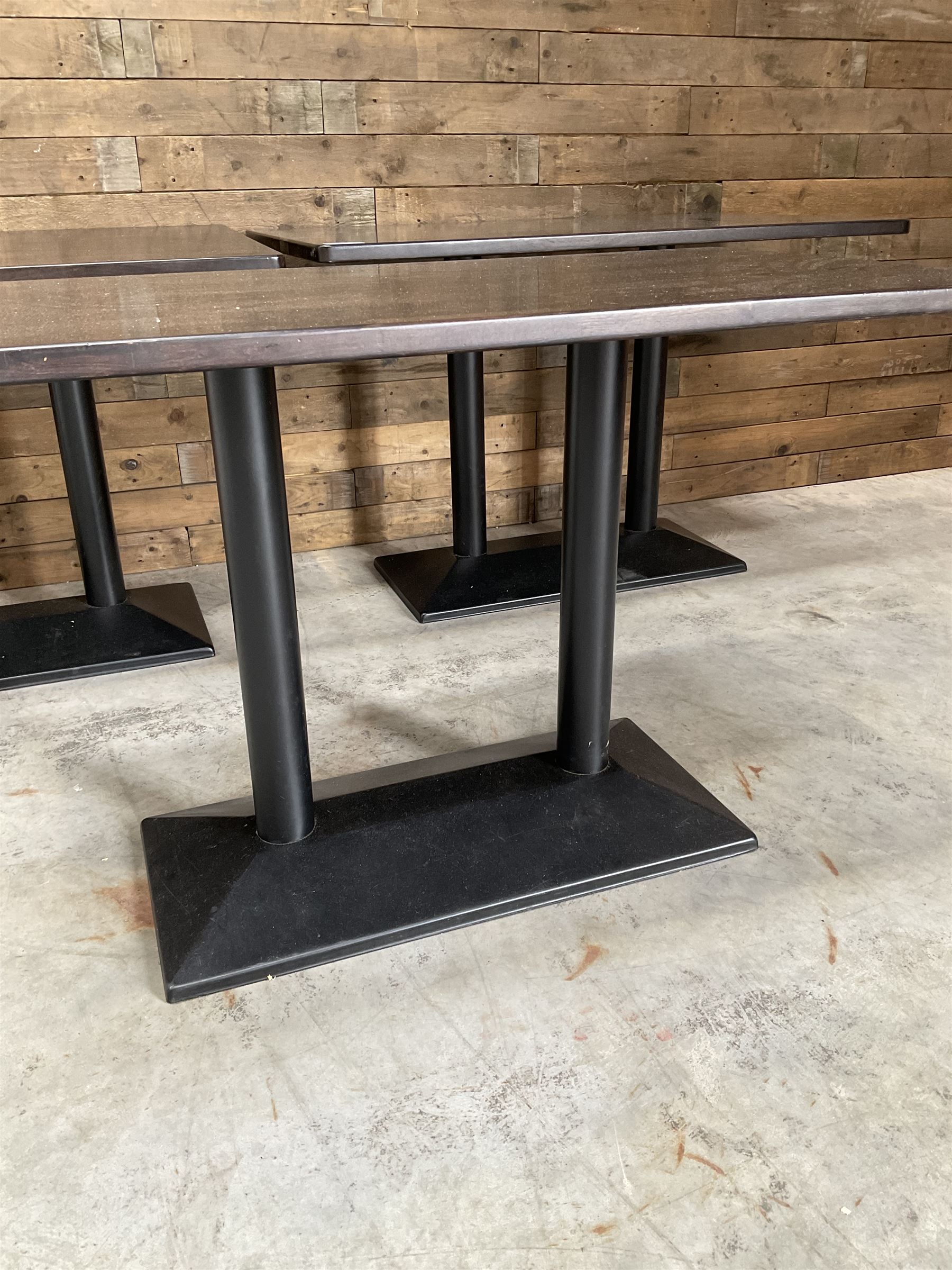 Three dark walnut rectangular console restaurant tables, on black metal bases