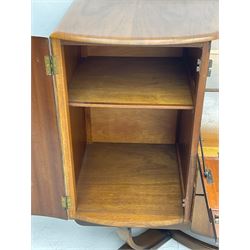 Beautility - mid-20th century walnut sideboard, fall-front with sliding top enclosing mirror interior, fitted with two drawers and flanking cupboards, on sledge feet with curved stretchers 