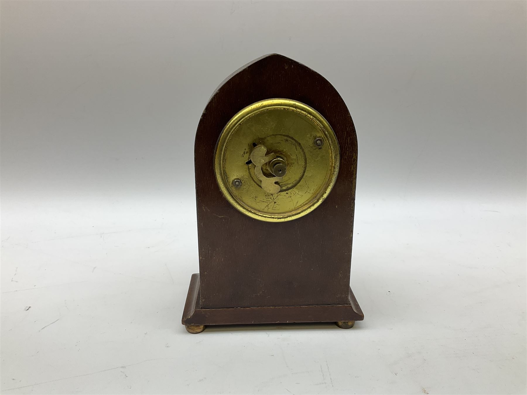 Edwardian mahogany and boxwood strung mantel lancet clock, the dial with black Roman numerals, marked 8 Day Made in U.S.A, upon four compressed bun type feet, H18.5cm