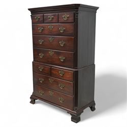 George III mahogany chest-on-chest, canted rectangular form, stepped cavetto moulded cornice, the upper section fitted with three short over three long drawers, the lower section fitted with two short over two long drawers, moulded drawer fronts with shaped and pierced handles plates and swan neck handles, enclosed by fluted corners with acanthus leaf capitals, on ogee bracket feet