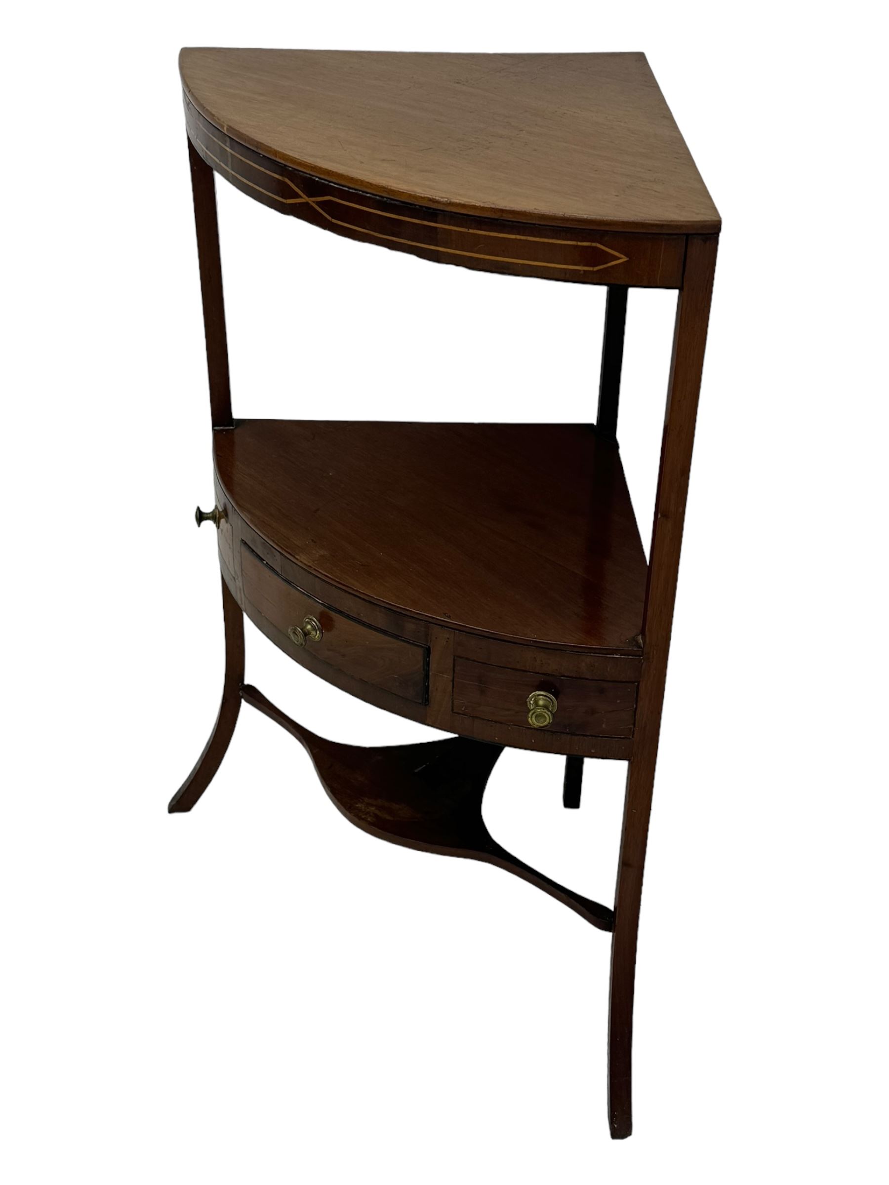 George III mahogany two-tier corner washstand, the inlaid top with geometric border, central drawer flanked by two faux drawers each with brass pull handle, on splayed supports united by shaped under-tier