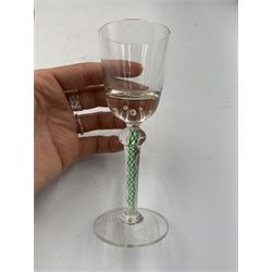 19th century continental liqueur glass, circa 1870, bucket bowl with bubble decoration, the tapered stem with green and white strands, H12.5cm; together with a Victorian aperitif glass, trumpet bowl decorated with foliate and fruiting vines, H10cm (2)