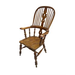 Elm and beech high back Windsor chair,  high hoop back with pierced splat and spindle supports over shaped saddle seat, raised on ring turned supports united by H-stretcher