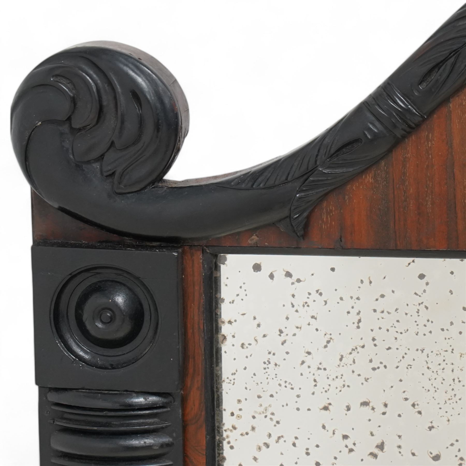 Early 19th century rosewood and ebonised overmantel mirror, scroll shaped pediment decorated with ebonised acanthus carved applied mounts, rib turned upright mounts enclosing rectangular mercury mirror plate, applied lower beaded edge 