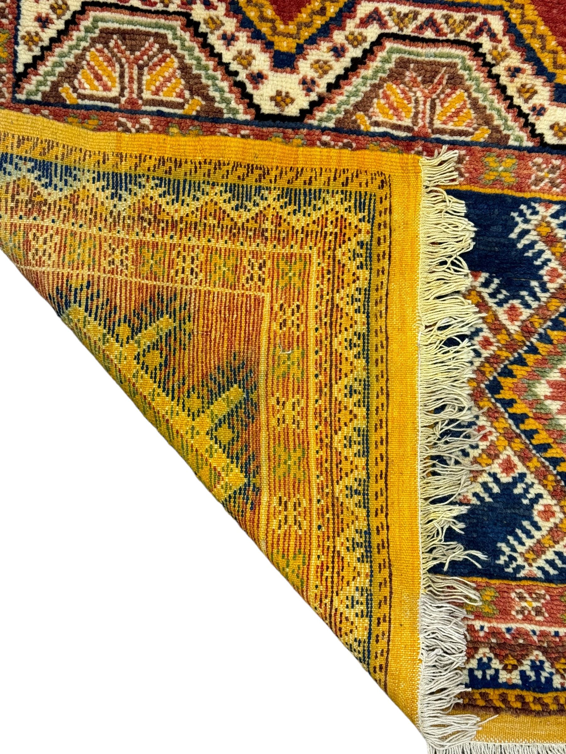 Persian Qashqai crimson ground rug, the field with central indigo and yellow medallion with geometric motifs, flanked by smaller medallions, border with repeating patterns (112cm x 200cm); Turkish Kazak light blue ground rug (109cm x 193cm); red ground runner with three octagonal medallions (69cm x 138cm)