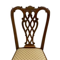 Set of twelve Chippendale design mahogany dining chairs, shaped cresting rail carved with foliage and C-scrolls, pierced interlaced splat with curled leaf decoration, upholstered drop-in seat, moulded seat rails, on scrolled acanthus carved cabriole supports with ball and claw feet 