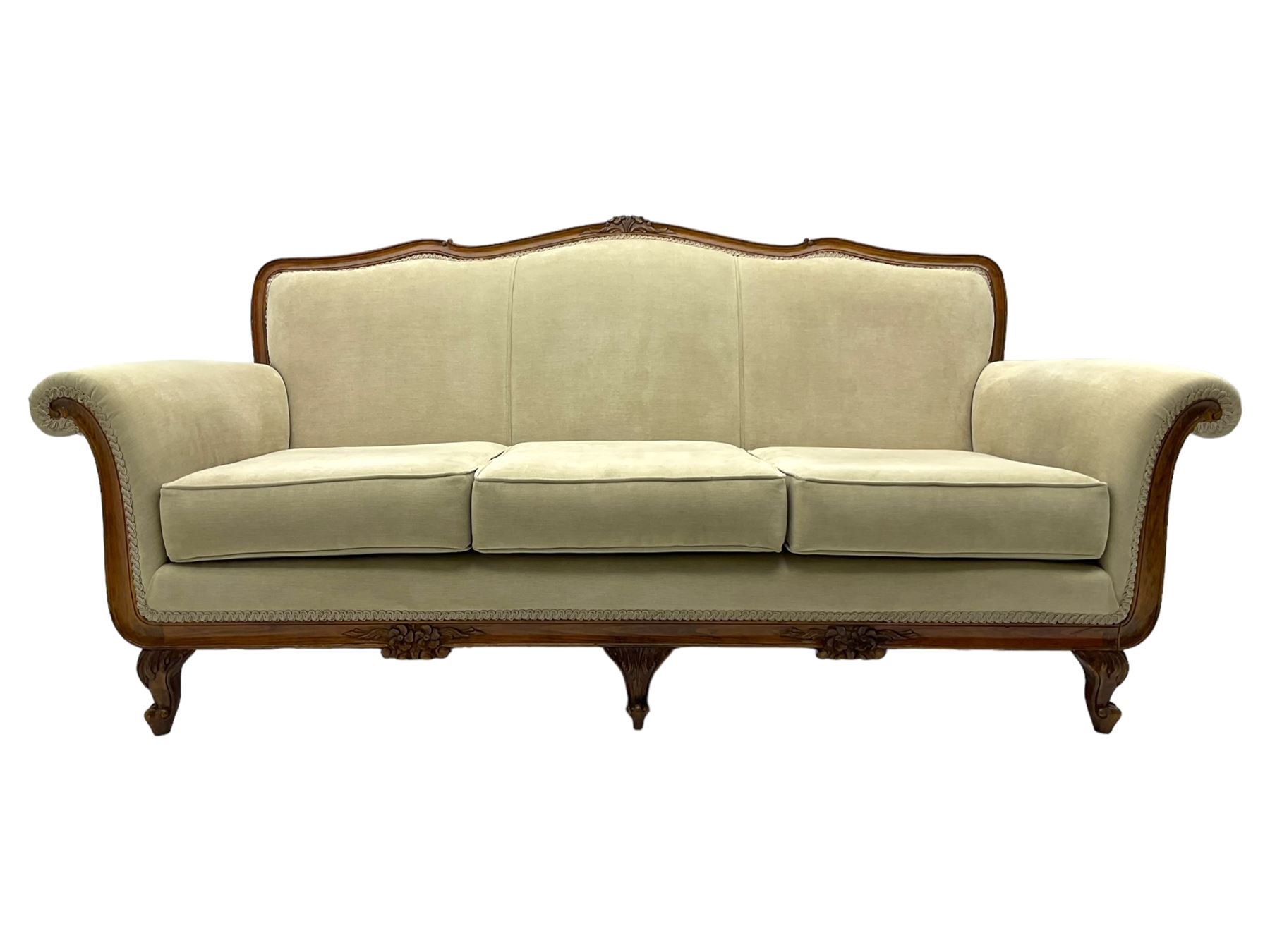 French design stained beech framed three-seat sofa, moulded frame carved with flowers and foliage, upholstered in pale neutral fabric, the moulded lower rail carved with flowerheads, on acanthus leaf carved cabriole feet