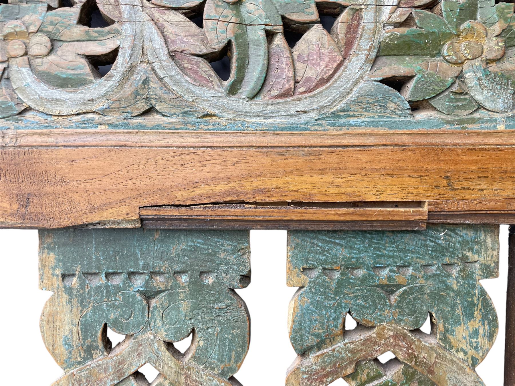 Early 20th century Javanese teak and hardwood door panel or room divider, rectangular panelled form with moulded frame and pegged construction, carved and pierced with scrolling decoration and flower head motifs, shaped and pierced splats with interlocking pattern