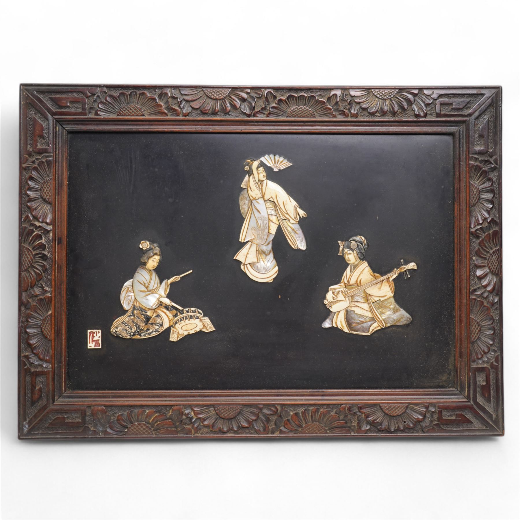 Early 20th century Japanese shibayama panel, the geisha figures moulded in bone and mother of pearl, depicted playing instruments and dancing, in carved frame, bearing signature 50cm x 55cm 