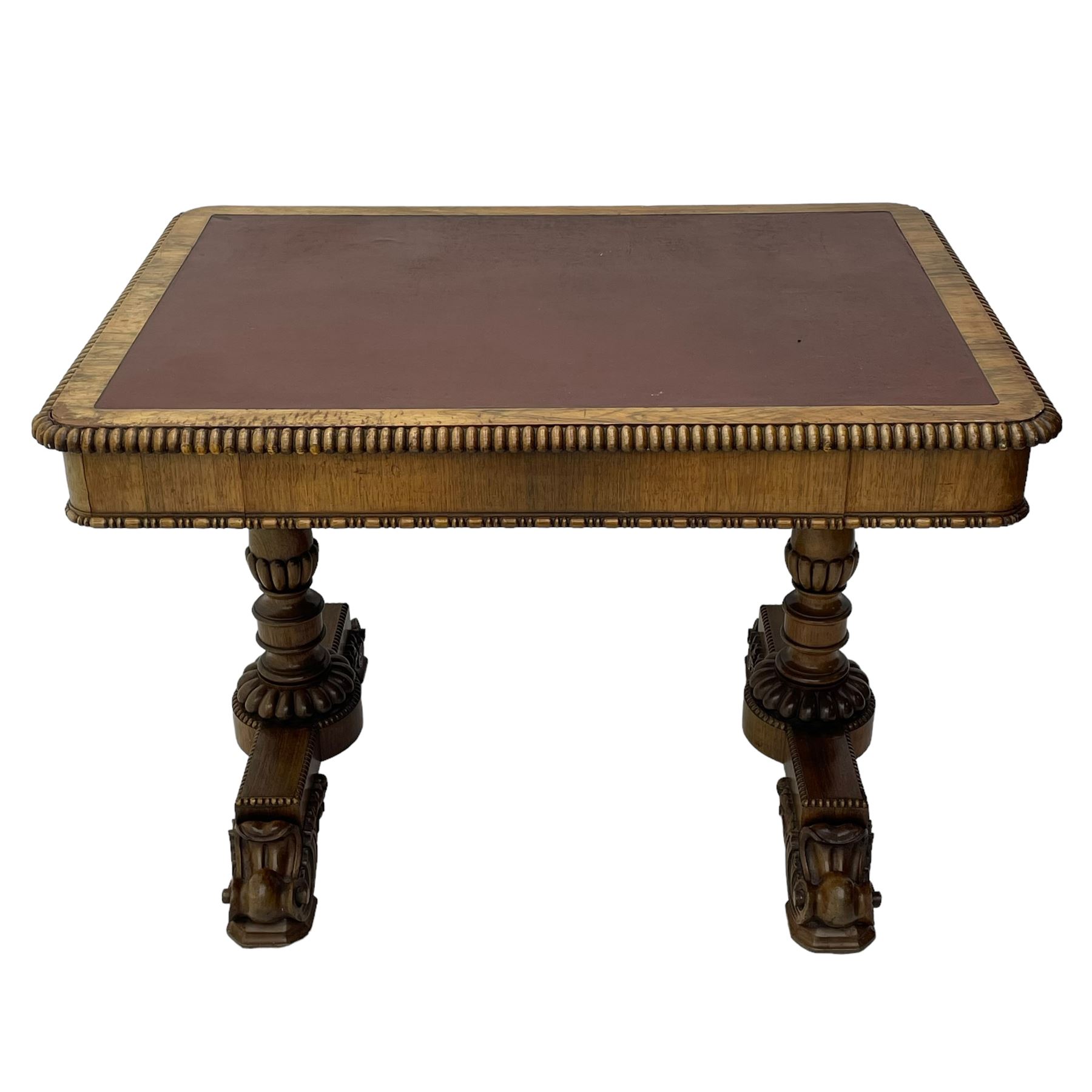 Early 19th century Regency rosewood writing table, rectangular top with inset leather writing surface and gadroon moulded edge, fitted with single frieze drawer, on twin turned pillar supports with lobe carved balusters, on platforms with beaded edge, acanthus scroll carved feet