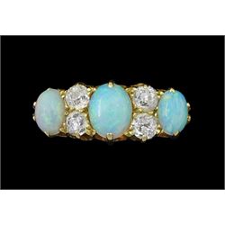 Early 20th century 18ct gold three stone opal, the centre stone set with two old cut diamonds either side, London 1913, total diamond weight approx 0.30 carat