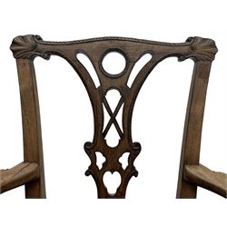 Unusual 18th century mahogany elbow chair, the shaped cresting rail with projecting shell carved ears, pierced and scroll carved splat over drop-in upholstered seat, shaped arms with ball and claw carved terminals, the seat rails carved with shell cartouches, on foliate carved cabriole supports with ball and claw feet 