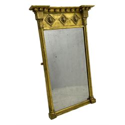 Regency giltwood and gesso pier mirror, projecting moulded cornice with globular mounts, the frieze decorated with three lion masks within lozenges, cluster column uprights with leaf decorated capitals, bevelled mirror plate